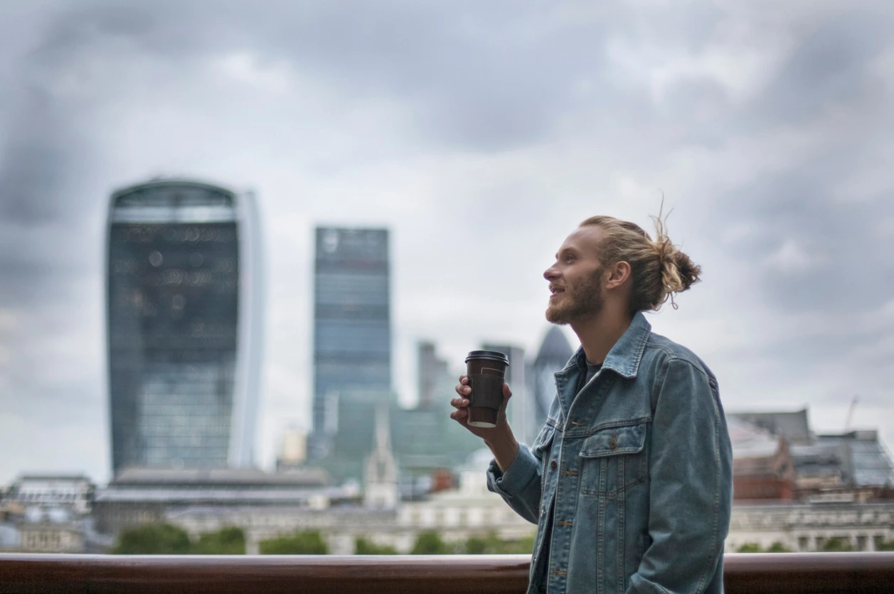 How Long Does Alcohol Recovery Take? A man drinking coffee in the street in London.