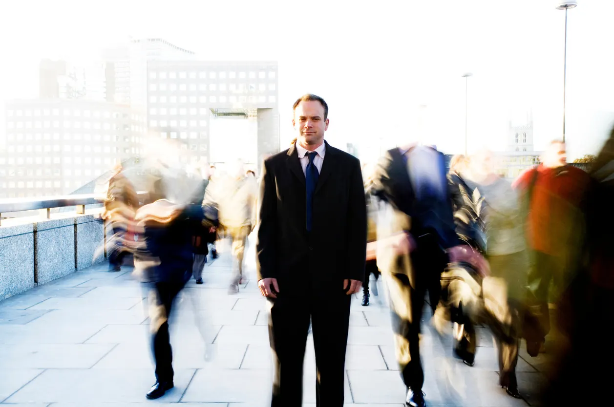 A businessman pausing on his way to work.